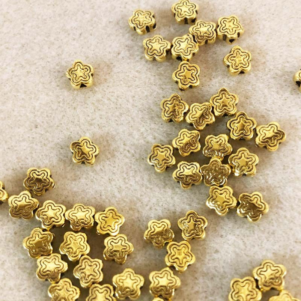 20 perles étoile, alliage doré. 7 mm