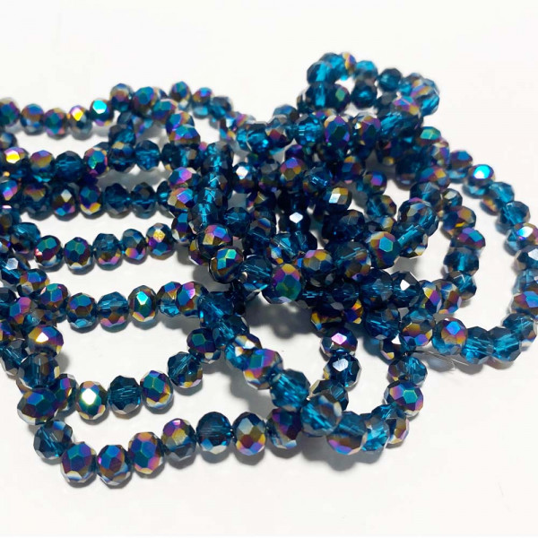 6*5 mm. Perles en verre à facettes. Bleu pétrole irisé. Le fil env. 92 perles